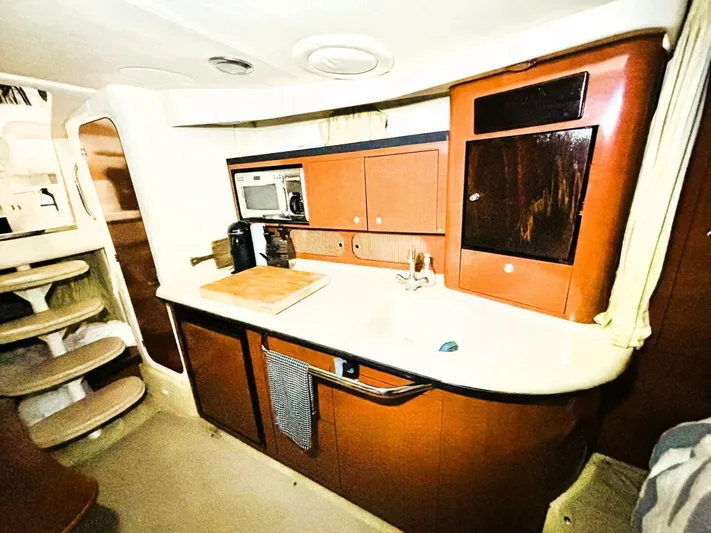  Yacht Photos Pics 2005 Sea Ray 340 Sundancer interior kitchen with wooden cabinets and modern appliances.