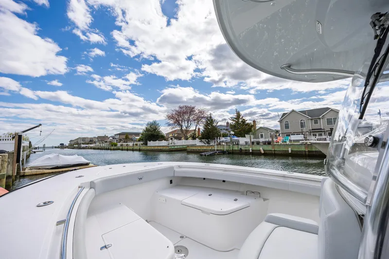 Makayla Lynam Yacht Photos Pics 2018 Southport 29 FE boat docked by waterfront homes under a partly cloudy sky.