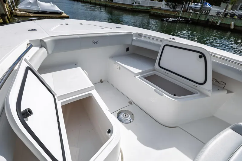 Makayla Lynam Yacht Photos Pics 2018 Southport 29 FE boat interior with open storage compartments by the water.