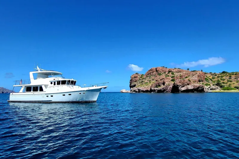 Felix Yacht Photos Pics Selene 53 Ocean Classic yacht, 2008, anchored near rocky island under clear blue sky.