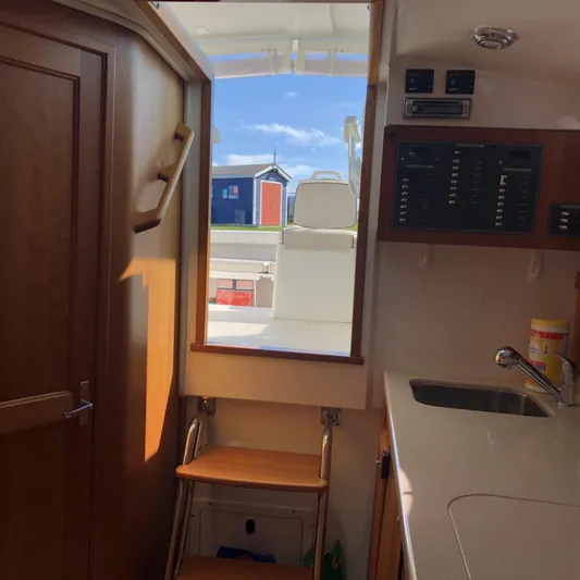Intermission Yacht Photos Pics Interior view of 2006 Back Cove 29 boat, featuring wooden steps and a compact kitchenette.