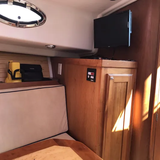Intermission Yacht Photos Pics Interior of 2006 Back Cove 29 boat with TV and wooden cabinetry.