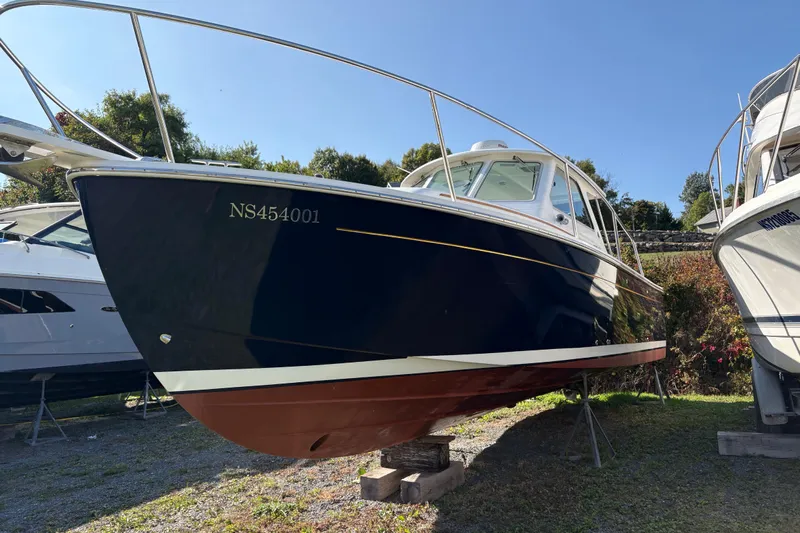 Intermission Yacht Photos Pics 2006 Back Cove 29 boat on dry dock, blue hull, sunny day.
