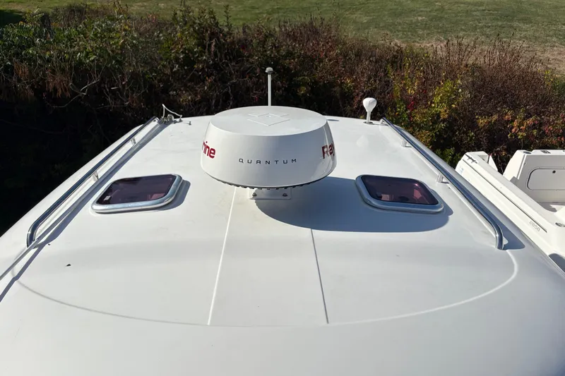 Intermission Yacht Photos Pics 2006 Back Cove 29 boat roof with radar and hatches, surrounded by greenery.