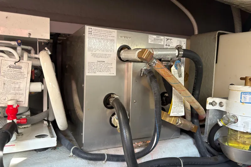 Intermission Yacht Photos Pics Engine compartment of a 2006 Back Cove 29 boat, showing mechanical components and hoses.