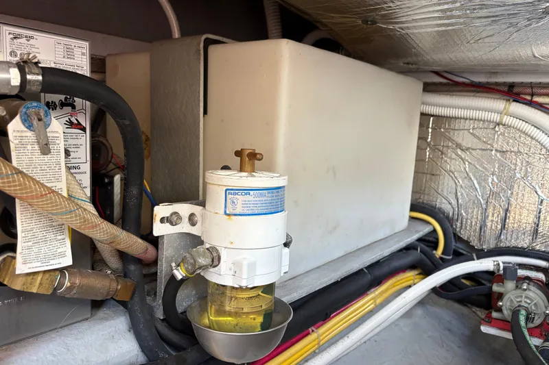 Intermission Yacht Photos Pics Engine compartment of a 2006 Back Cove 29 boat, featuring fuel filter and hoses.