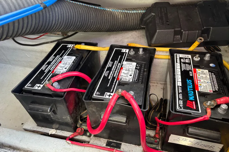 Intermission Yacht Photos Pics Three marine batteries with red and yellow cables in a 2006 Back Cove 29 boat.