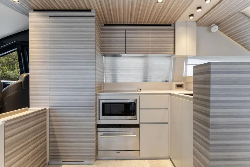 Only One Yacht Photos Pics Modern kitchen interior of 2020 Ferretti Yachts 670, featuring sleek cabinetry and appliances.