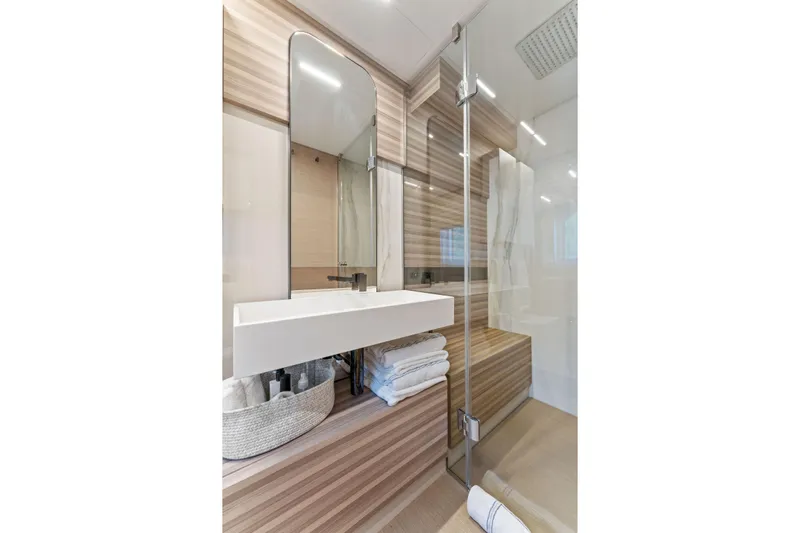 Only One Yacht Photos Pics Luxurious bathroom in 2020 Ferretti Yachts 670, featuring modern sink and glass shower.