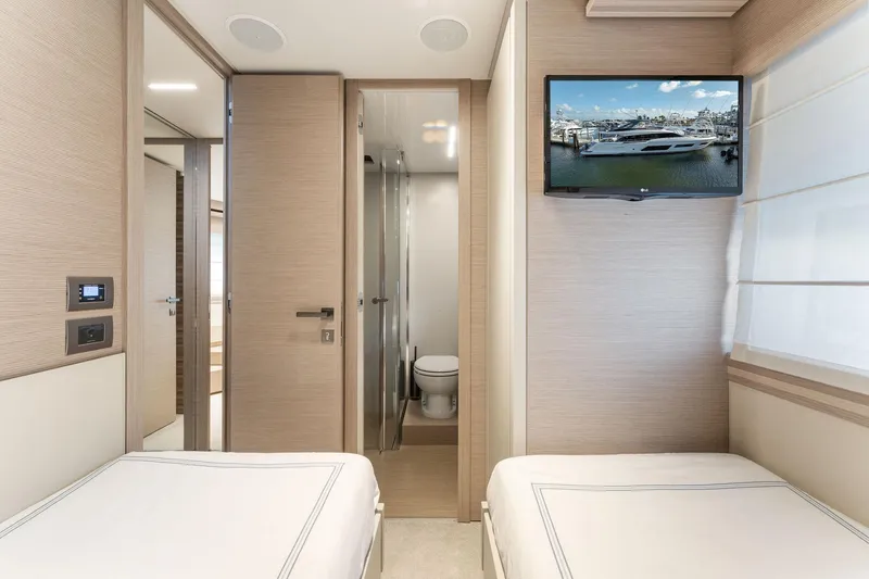 Only One Yacht Photos Pics Interior of 2020 Ferretti Yachts 670 cabin with twin beds and wall-mounted TV.