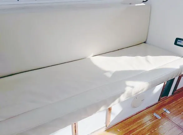 Riverwind Yacht Photos Pics 2008 Eastern Casco Bay 31 boat interior with beige cushioned seating and wooden flooring.