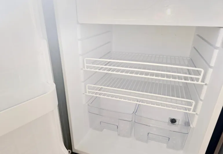 Riverwind Yacht Photos Pics Empty refrigerator interior with wire shelves and drawers, part of a 2008 Eastern Casco Bay 31.