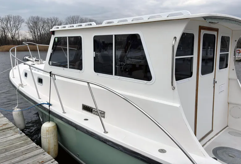 Riverwind Yacht Photos Pics 2008 Eastern Casco Bay 31 boat docked, featuring a white cabin and sleek design.