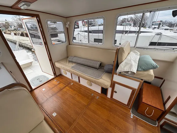 Riverwind Yacht Photos Pics Interior of 2008 Eastern Casco Bay 31 boat with wooden flooring and cushioned seating.