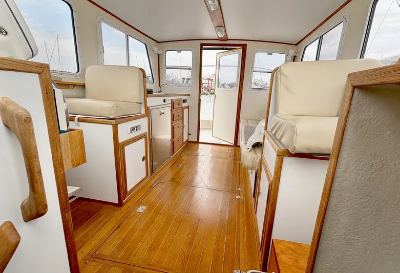 Riverwind Yacht Photos Pics Interior of 2008 Eastern Casco Bay 31 boat with wood flooring and beige seating.