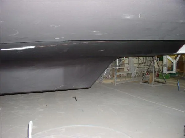  Yacht Photos Pics 2022 Westport hull project in a workshop setting, showcasing unfinished boat construction.