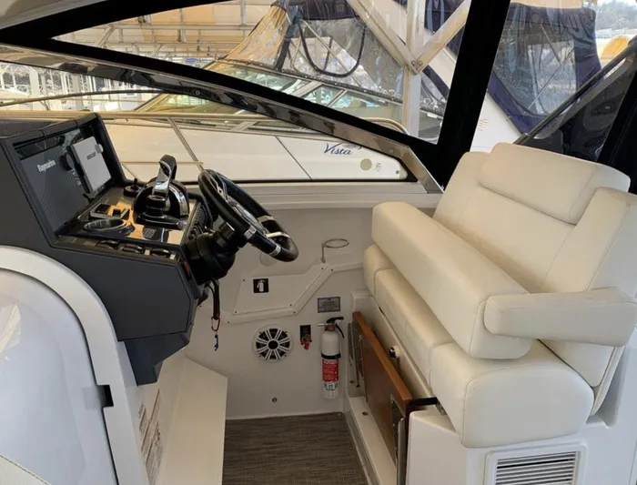  Yacht Photos Pics 2018 Cruisers 390 Express Coupe helm with modern controls and plush seating.