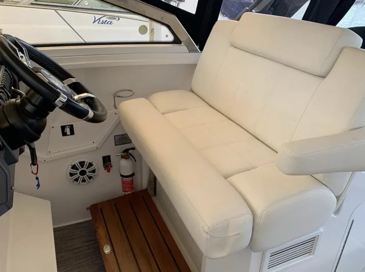  Yacht Photos Pics 2018 Cruisers 390 Express Coupe interior with white seating and steering wheel.