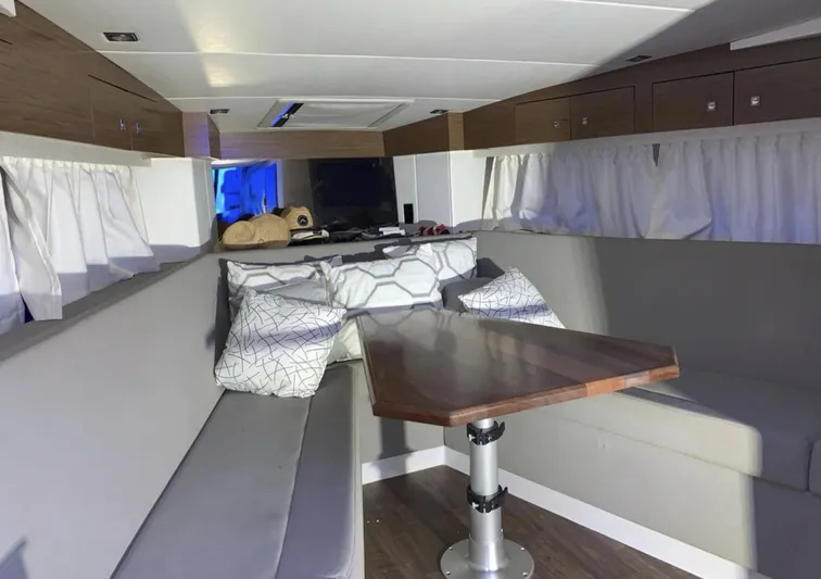  Yacht Photos Pics Interior of 2018 Cruisers 390 Express Coupe with modern seating and wooden table.