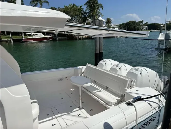  Yacht Photos Pics 2022 Intrepid 407 Nomad SE boat docked with palm trees in background.