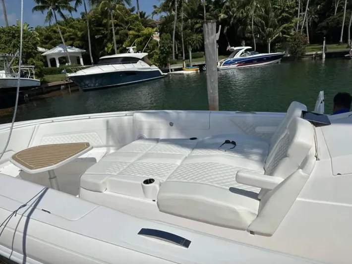  Yacht Photos Pics Intrepid 407 Nomad SE 2022, luxurious boat seating area by the water.