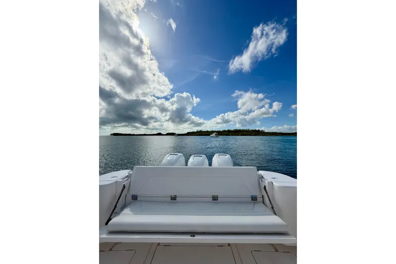  Yacht Photos Pics Intrepid 407 Nomad SE 2022 boat on calm water under a partly cloudy sky.