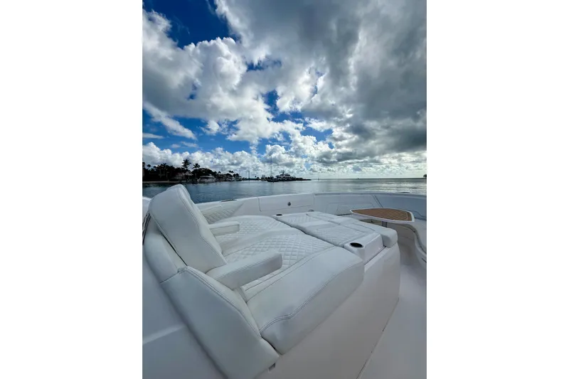  Yacht Photos Pics Luxurious seating on 2022 Intrepid 407 Nomad SE boat under dramatic cloudy sky.