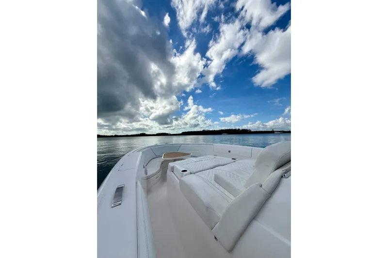  Yacht Photos Pics 2022 Intrepid 407 Nomad SE boat on calm water under a partly cloudy sky.