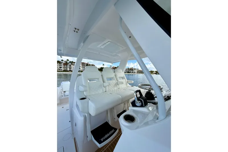  Yacht Photos Pics Interior of 2022 Intrepid 407 Nomad SE boat with luxurious seating and waterfront view.