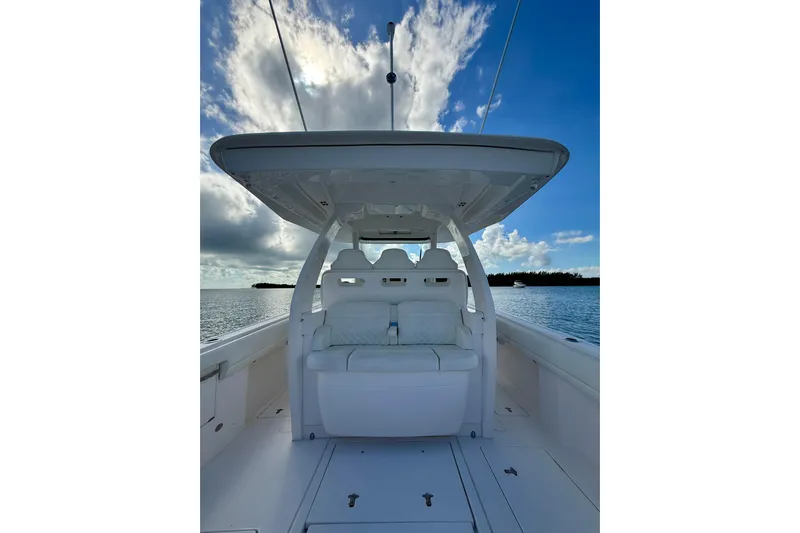  Yacht Photos Pics 2022 Intrepid 407 Nomad SE boat interior with seating, under a blue sky.