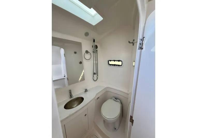  Yacht Photos Pics 2022 Intrepid 407 Nomad SE boat bathroom with sink, toilet, and shower.