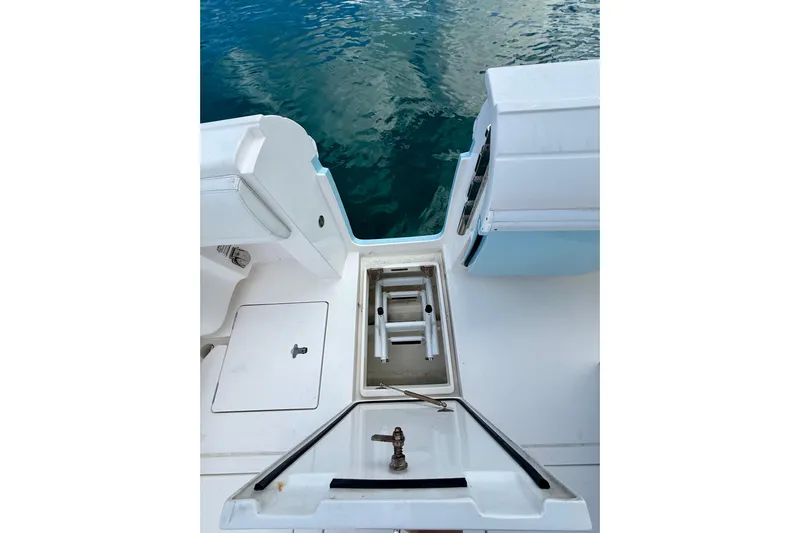  Yacht Photos Pics 2022 Intrepid 407 Nomad SE boat deck with storage compartments and ocean view.
