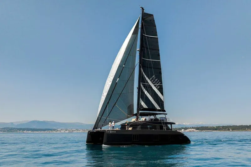 Black Raptor Yacht Photos Pics 2024 Sunreef 60 Eco sailing yacht on calm blue waters.