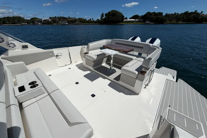 Marilee Yacht Photos Pics 2024 Tiara Yachts 43 LS luxury deck with seating and table on calm water.