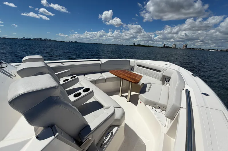 Marilee Yacht Photos Pics 2024 Tiara Yachts 43 LS luxury boat interior with seating and table, on a sunny day.