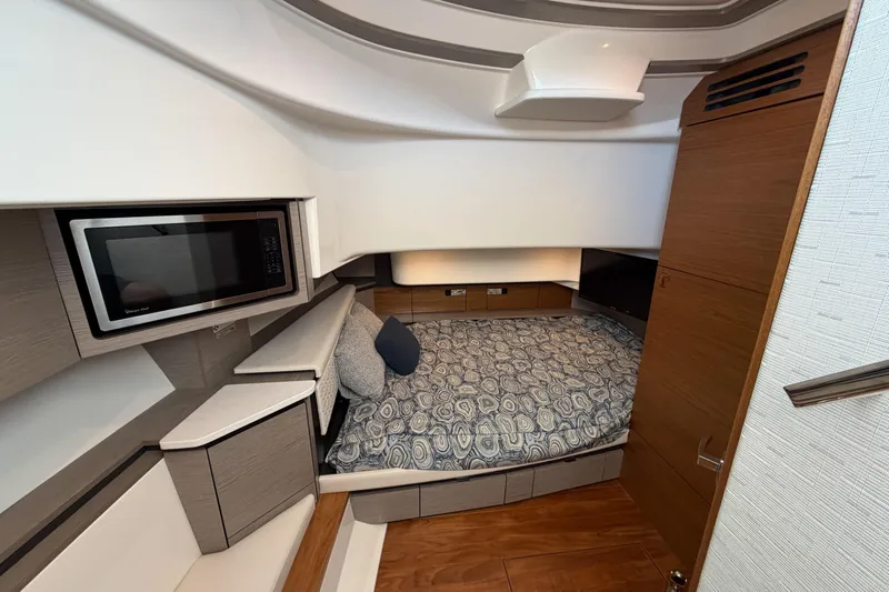 Marilee Yacht Photos Pics Luxurious cabin interior of 2024 Tiara Yachts 43 LS with bed and microwave.