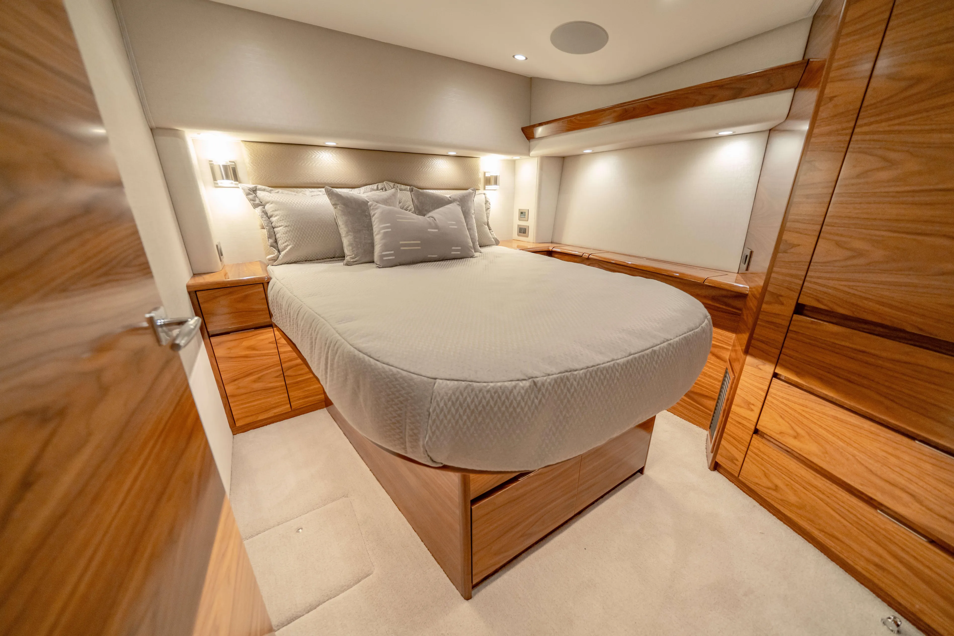 2026 Viking 50c Yacht Photos Pics Luxurious bedroom interior of 2026 Viking 50 Convertible yacht with elegant wood finishes.
