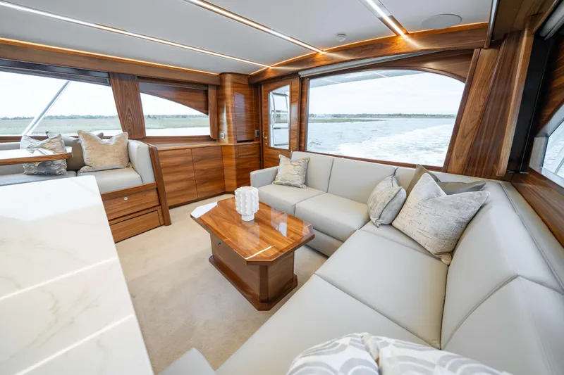 2026 Viking 50c Yacht Photos Pics Luxurious interior of 2026 Viking 50 Convertible yacht with elegant wood finishes and plush seating.