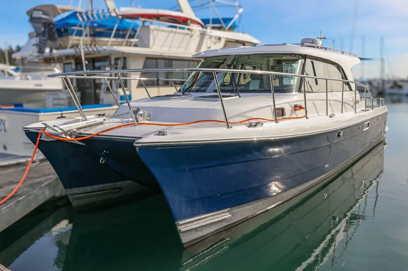 Sojourn Yacht Photos Pics 2022 Aspen C108 boat docked in marina, featuring sleek design and blue hull.
