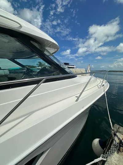 Yacht Photos Pics 2023 Tiara Yachts C49 Coupe docked under a clear blue sky.