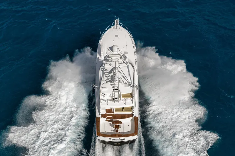 Benedetta Yacht Photos Pics Aerial view of 2012 Viking 70 Enclosed Bridge yacht cruising through blue ocean waters.