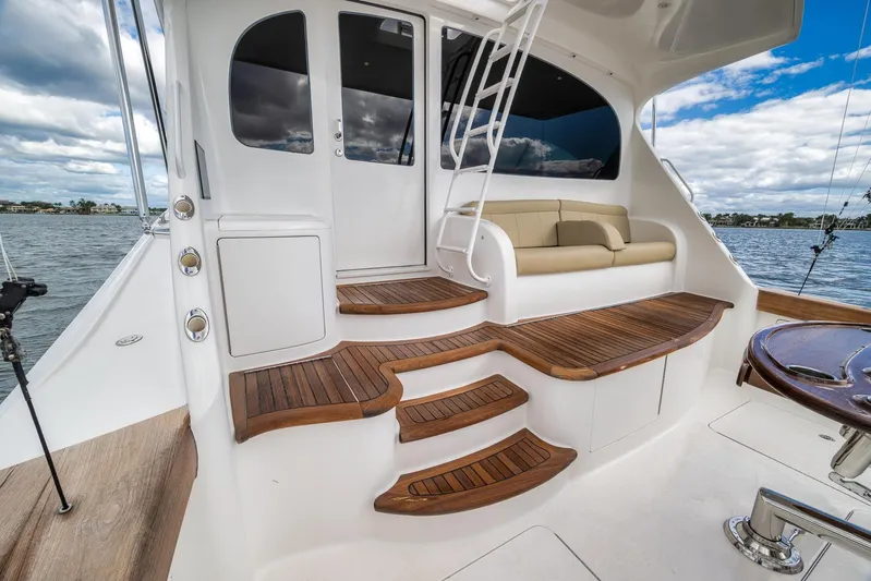 Benedetta Yacht Photos Pics 2012 Viking 70 Enclosed Bridge yacht with elegant wooden steps and seating area.