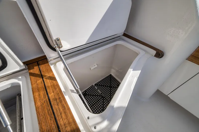 Benedetta Yacht Photos Pics Storage compartment on 2012 Viking 70 Enclosed Bridge yacht with wooden trim.