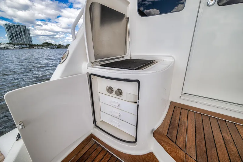 Benedetta Yacht Photos Pics Outdoor kitchenette on 2012 Viking 70 Enclosed Bridge yacht with ocean view.
