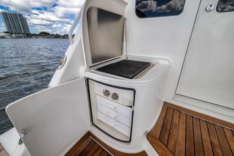 Benedetta Yacht Photos Pics Outdoor grill and storage on 2012 Viking 70 Enclosed Bridge yacht deck.