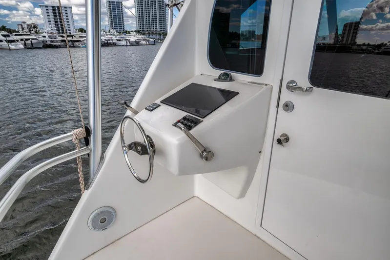 Benedetta Yacht Photos Pics 2012 Viking 70 Enclosed Bridge yacht helm with steering wheel and control panel.