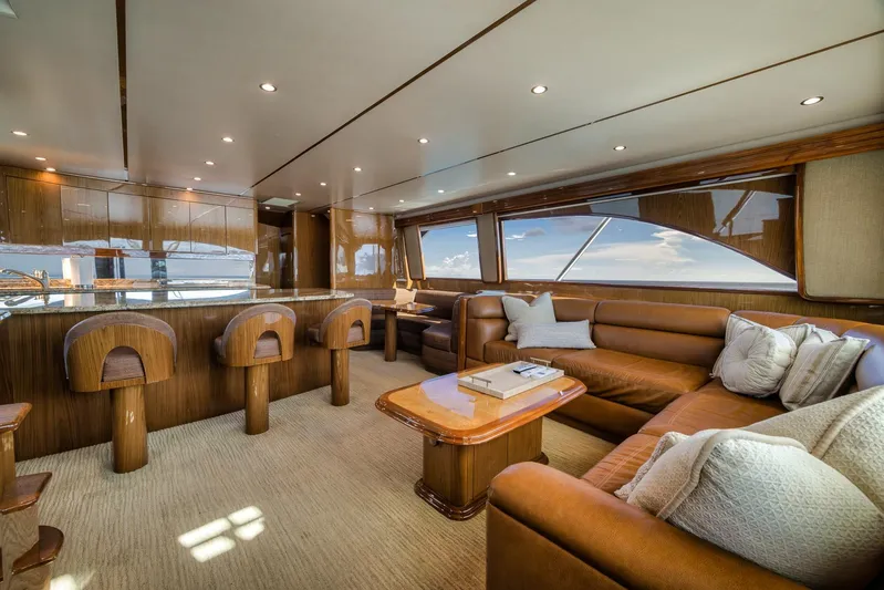 Benedetta Yacht Photos Pics Luxurious interior of 2012 Viking 70 Enclosed Bridge yacht with leather seating and bar stools.