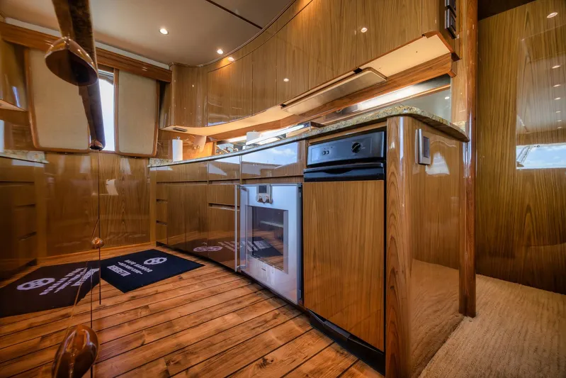 Benedetta Yacht Photos Pics Luxurious kitchen interior of 2012 Viking 70 Enclosed Bridge yacht with wood finish.