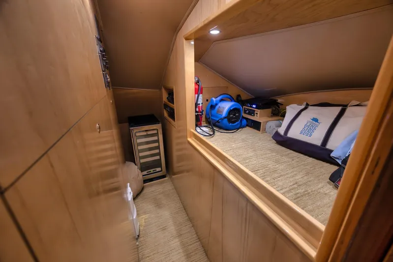 Benedetta Yacht Photos Pics 2012 Viking 70 Enclosed Bridge interior with storage, equipment, and a cozy sleeping area.