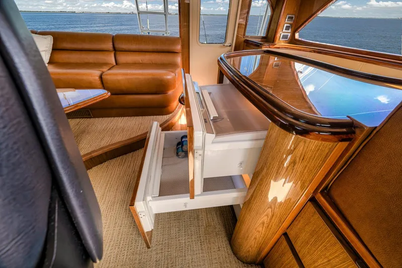 Benedetta Yacht Photos Pics Luxurious interior of 2012 Viking 70 Enclosed Bridge yacht with leather seating and ocean view.